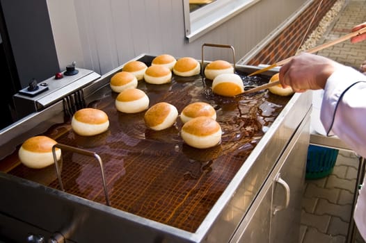 Frying of bud on fresh oil in midday (southern) poland by employee of (staff of) caf�