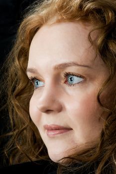 Portrait of a beautiful blue eyed woman on black background