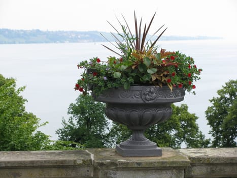 Bundle of flowers on wall, Background a lake