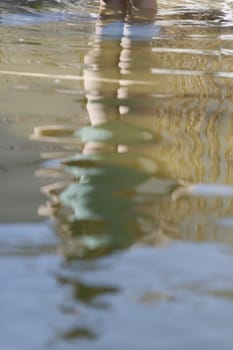 A girl is reflected in the pond