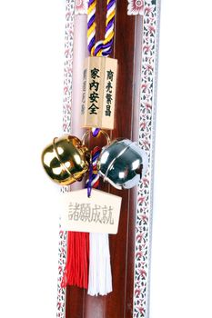 A Japanese Feng Shui bell, hung on the fret board of a traditional Indian string instrument.