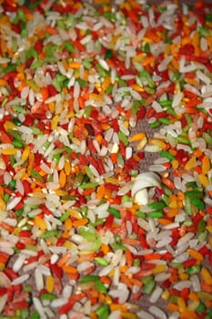 A background of colorful rice grains used in hindu rituals.