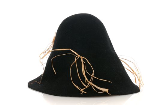 Scarecrow black felt hat with some straw isolated on white background.