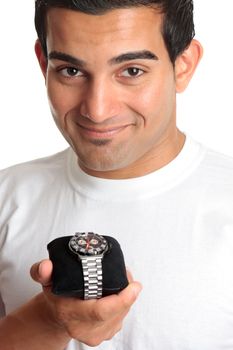 A smiling man holding a chronograph wrist watch with metal bracelet.  White background.