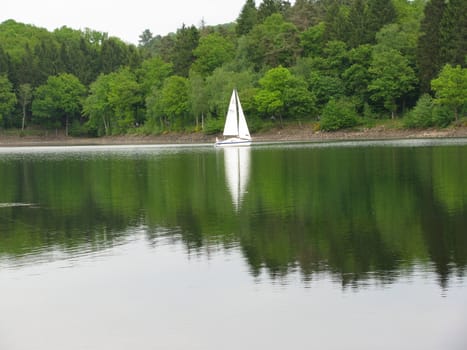 Sailing ship with reflexion in the lake