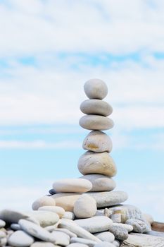 Vertical pile of pebbles on sea shore