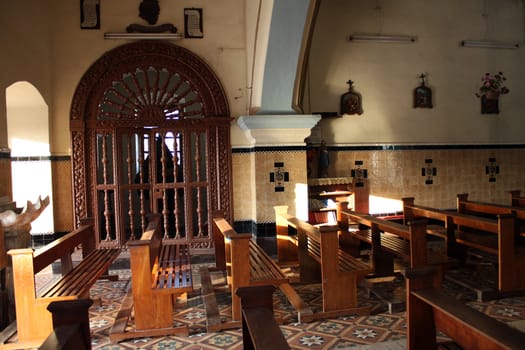 A view of the beautiful architecture and sitting wooden benches in a church.