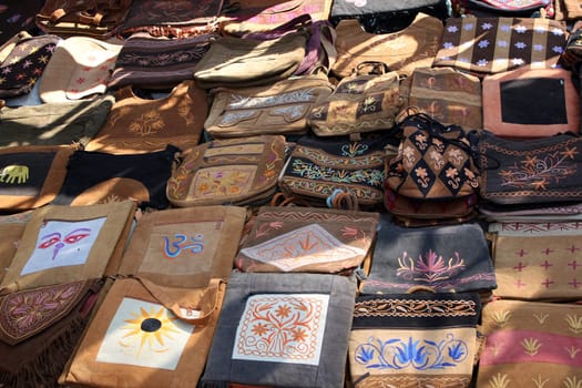 Handmade ethnic bags for sale in an Indian flea shop.