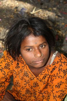 A portrait of a poor teenage Indian girl in a yellow dress.