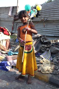 A very poor girl from India selling balloons to make a living.