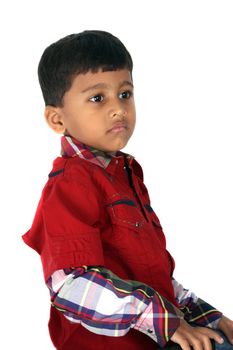 A portrait of an Indian boy in a unhappy mood, on white studio background.