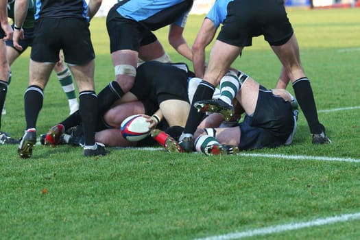 rugby being played by men on a grass pitch
