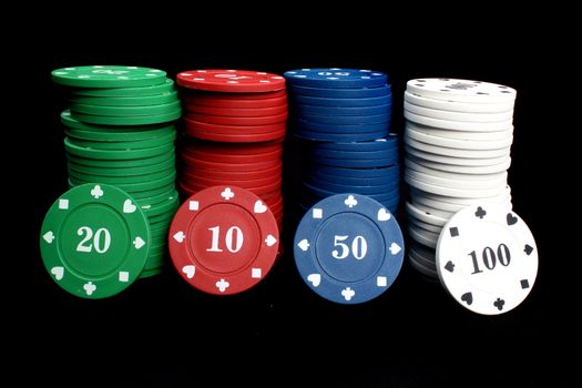 A set of casino chips / counters, on black studio background.