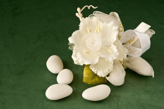 candy wedding favors and packaging materials on a green background