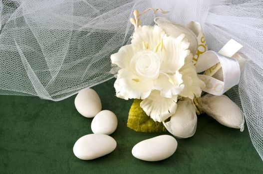 candy wedding favors and packaging materials on a green background