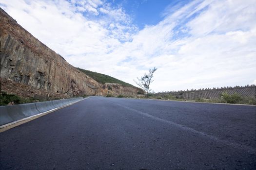 Asphalt road blue sky with clouds and mountains 