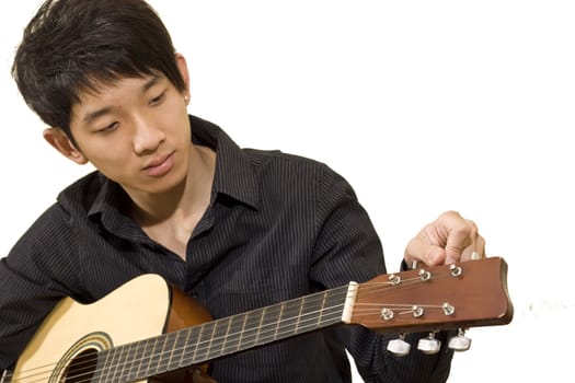 asia boy plays his guitar 