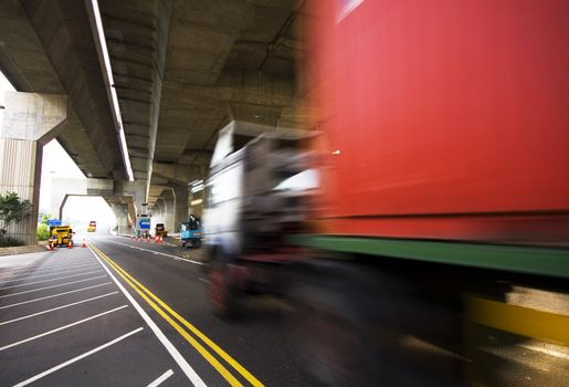 highway under the bridge and container car moving