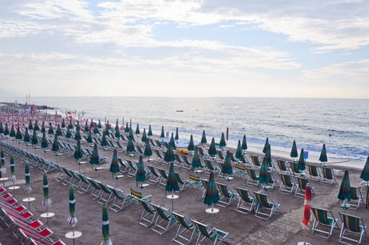 Shore beach with sun umbrella and deckchairs