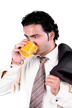 A young Indian businessman drinking coffee during a business break.