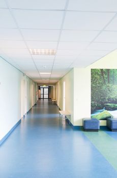 Long corridor in hospital with doors and reflections 