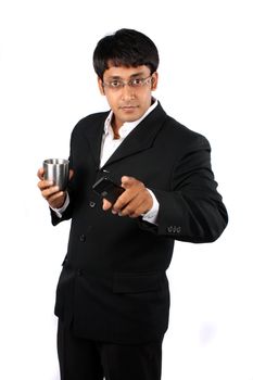 A confident Indian businessman pointing at the camera, on white studio background.