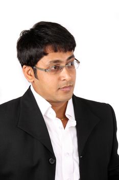 A portrait of a smart Indian businessman wearing glasses, on white studio background.