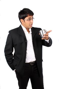An Indian businessman with a coffee mug in his hand, having an argument during an office break.