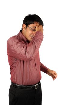 A tired Indian businessman wiping the sweat of his forehead, on white studio backgroun.
