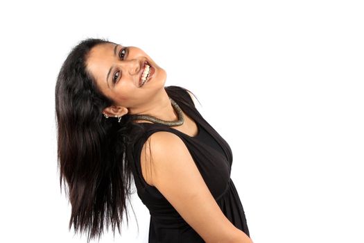 A beautiful Indian woman in black dress in a happy mood, on white studio background.