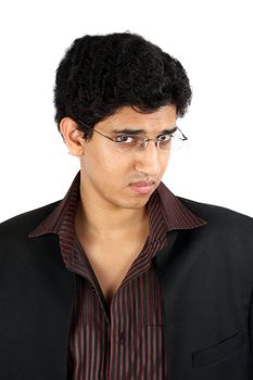 A portrait of a handsome young Indian businessman with an anxious look on his face.