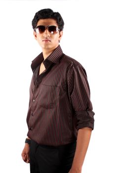 A handsome Indian teenage model posing in style, on white studio background.