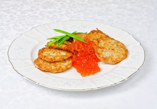 pancakes with red caviar and green onion closeup dish