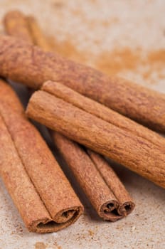 Cinnamon stick closeup on a brown background