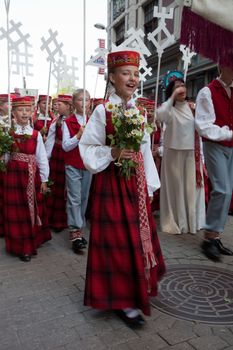 RIGA, LATVIA - JULY 10: A parade by festival participants of Latvian Youth Song and Dance Celebration through the centre of Riga, 10 July, 2010