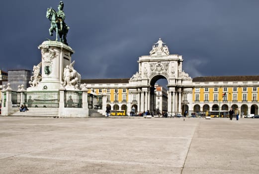 A stormy looking Commercial Plaza, Arco Triunfal and King João I statue in Lisbon, Portugal.