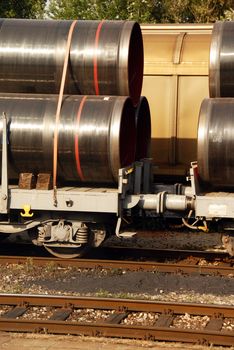 details of cargo train wagons with pipes on railway