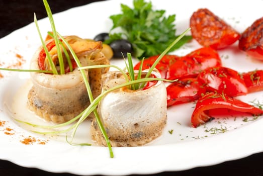 fillet of pikeperch stuffed with trout fish with baked pepper, tomato and leek
