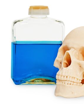 Still life - a bottle of poison and a human skull on white