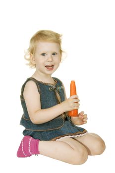 small girl with carrot on white background