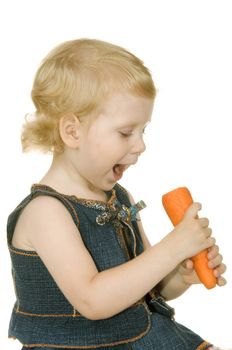 small girl with carrot on white background