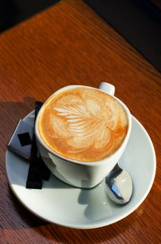 Cappuccino coffee cup closeup at the table