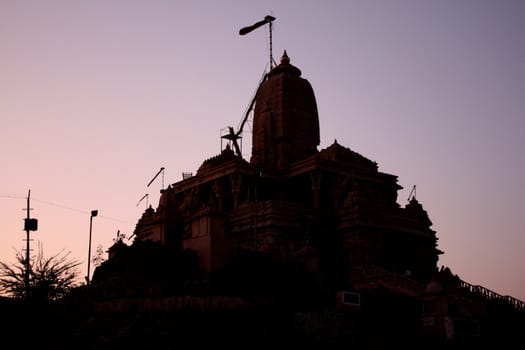 A silhouette of a temple on a twilight sky, in India.