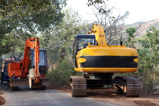 Dozers working at a road construction site, in India.