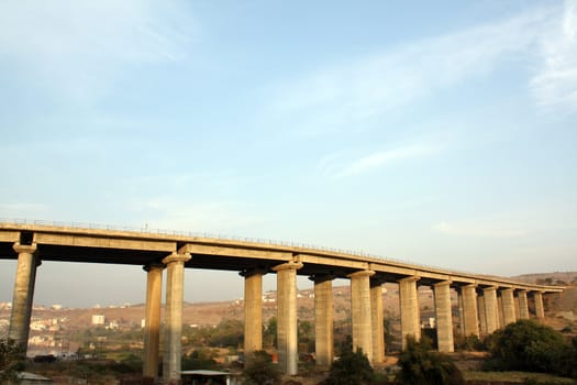 The architecture of a huge bridge in urban India.