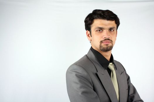 A portrait of a smart Indian businessman in a suit.