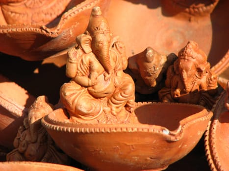 A traditional clay lamp with a design of hindu lord Ganesha.