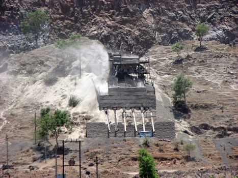 A stone quarry mining stones in a mountain, in India.