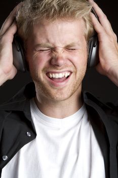 Blond boy listening to headphones music