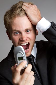 Business man yelling into phone